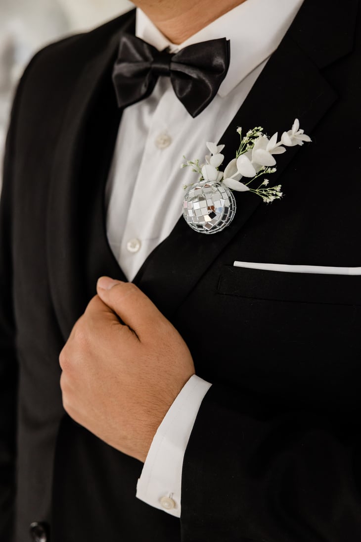 Groom Putting on Tuxedo